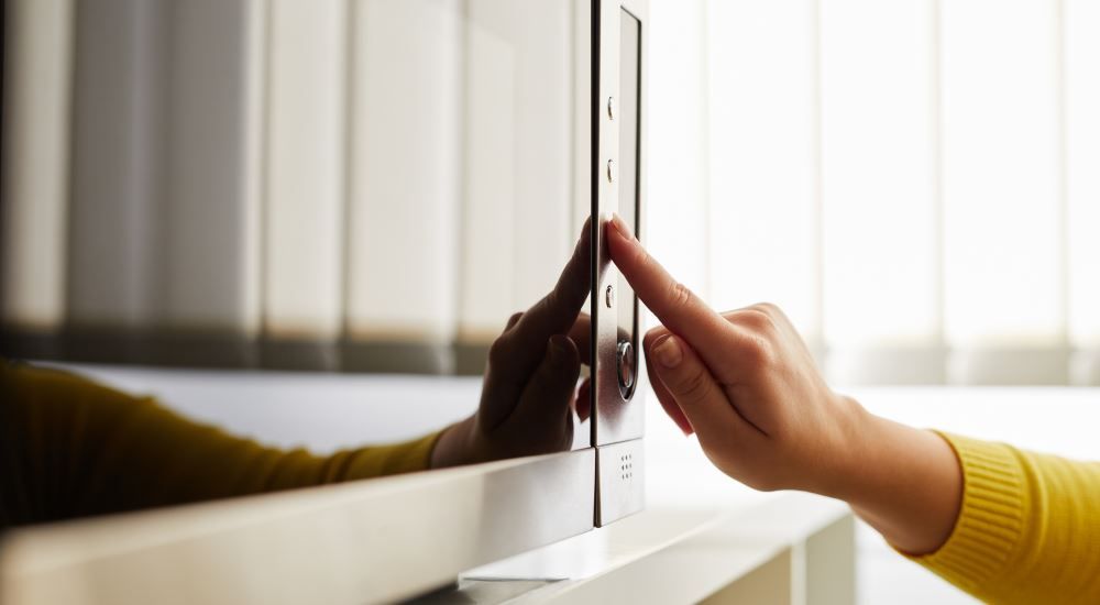 Photo of a hand pressing buttons on a microwave