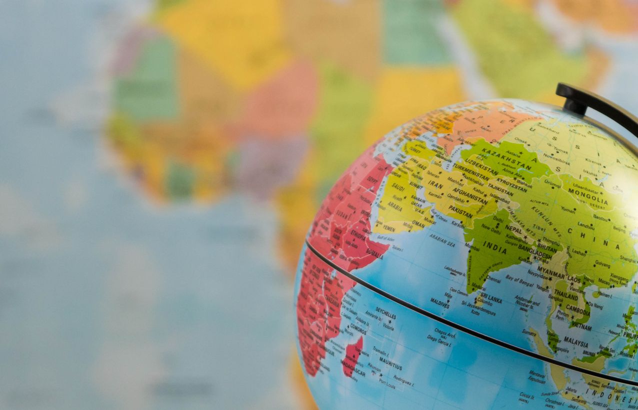 Photo of a globe in front of a map