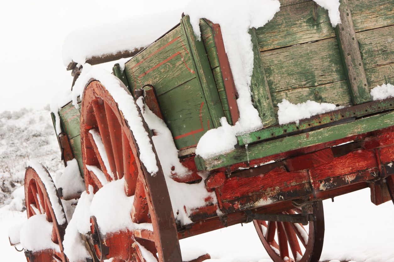 Stagecoach wagon covered in snow and ice in the middle of winter