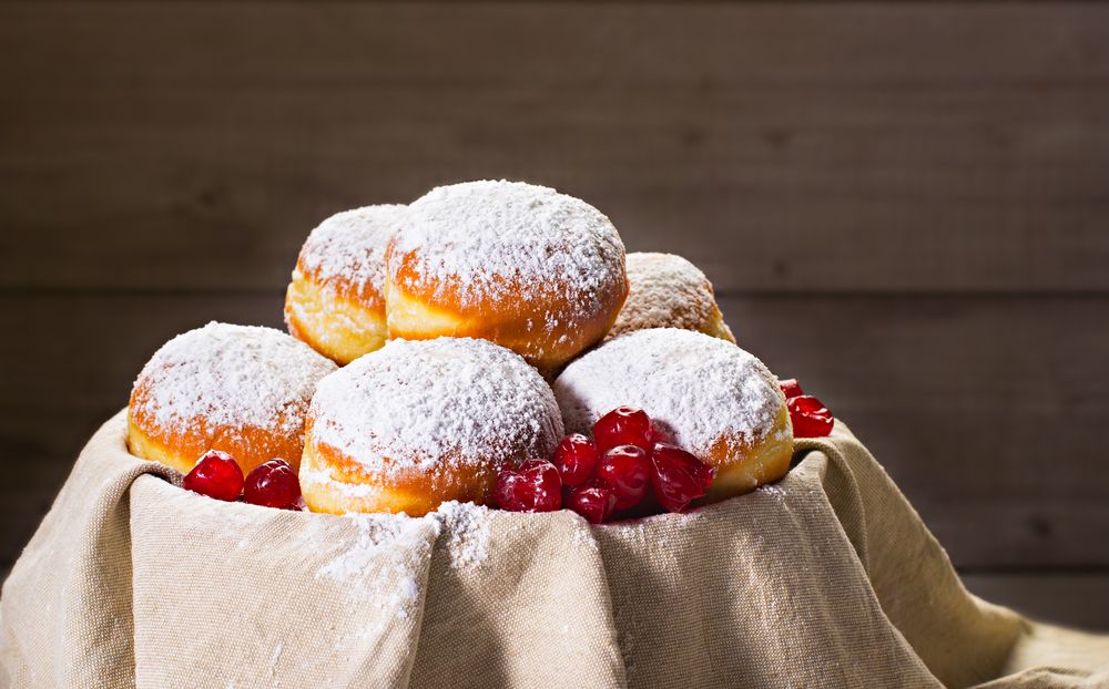 Bowl of traditional Jewish donuts sufganiyot, covered with powered sugar