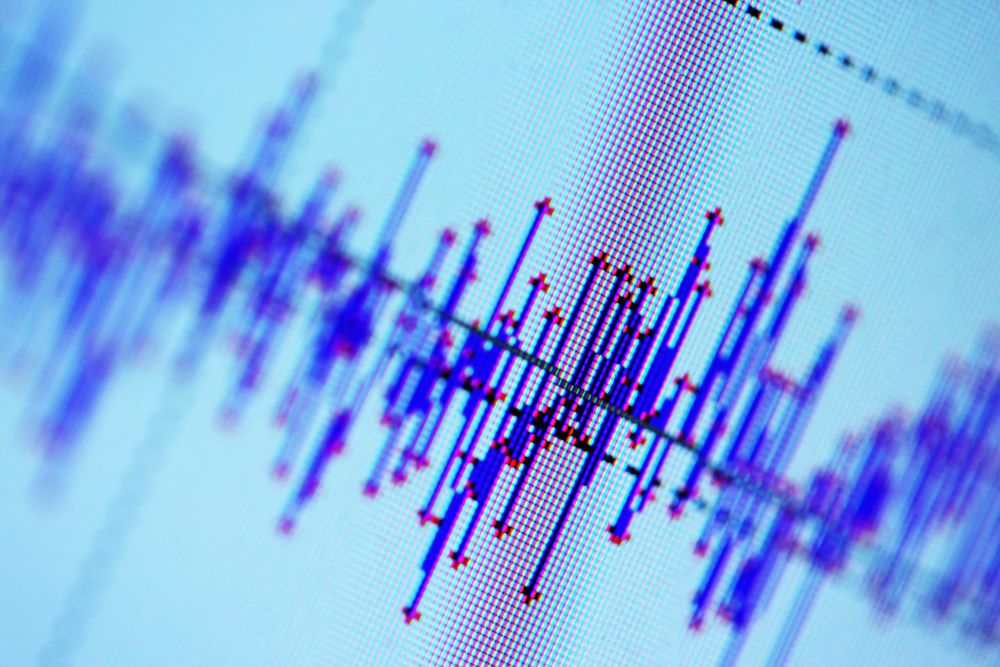 Up close view of a computer screen showing seismic activity in blue lines