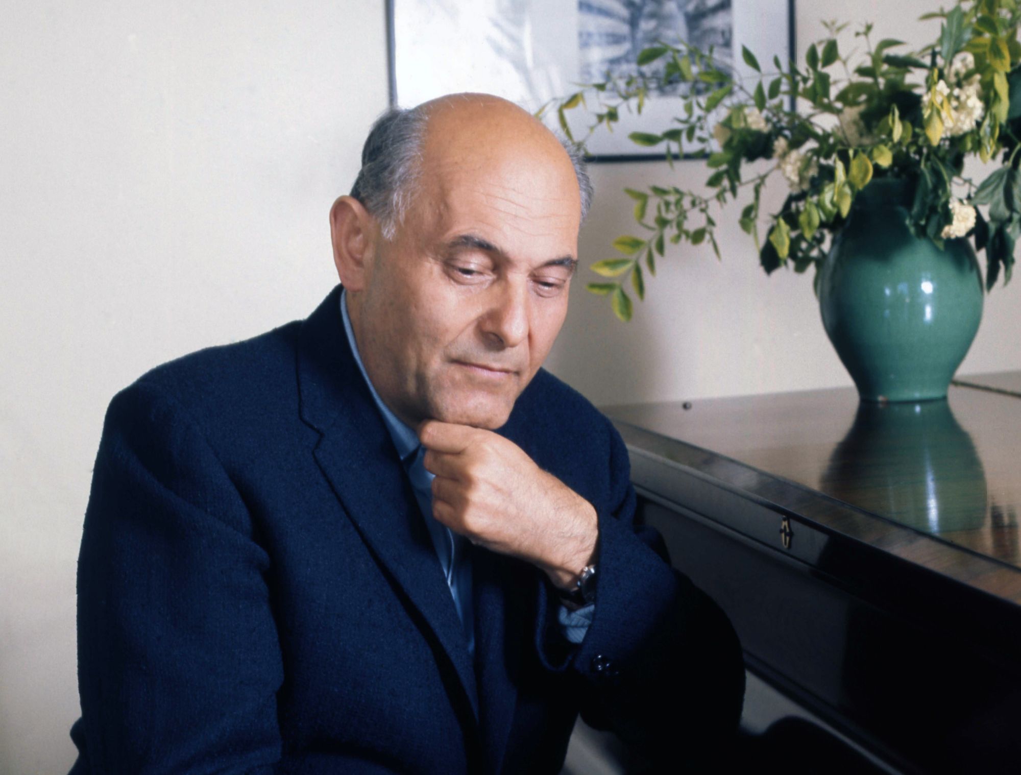 Georg Solti posing for photo at the piano
