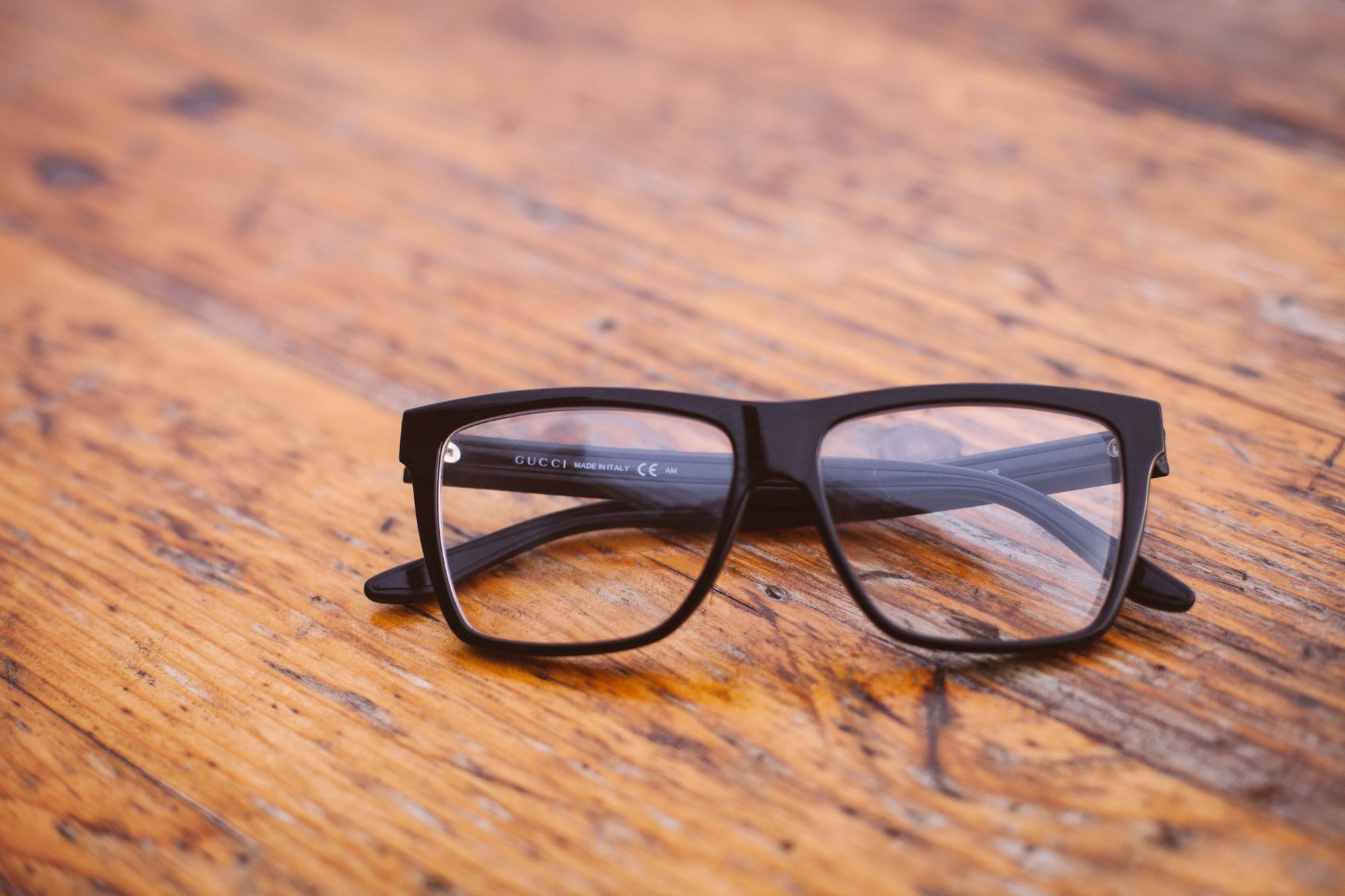 A pair of glasses sitting on a wooden table