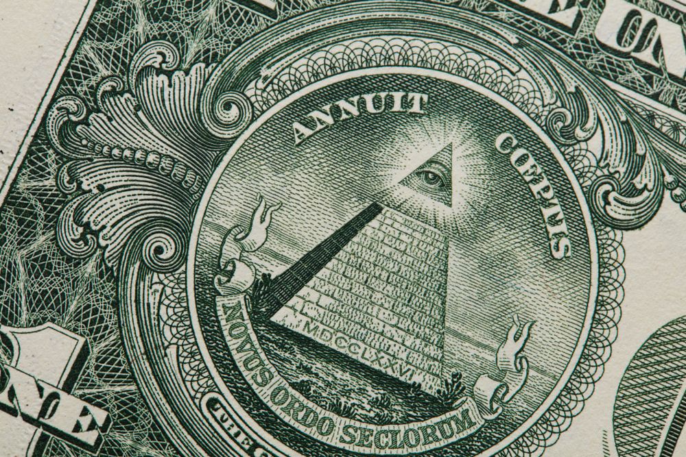 Up close view of American dollar bill showing iconic eye and imagery