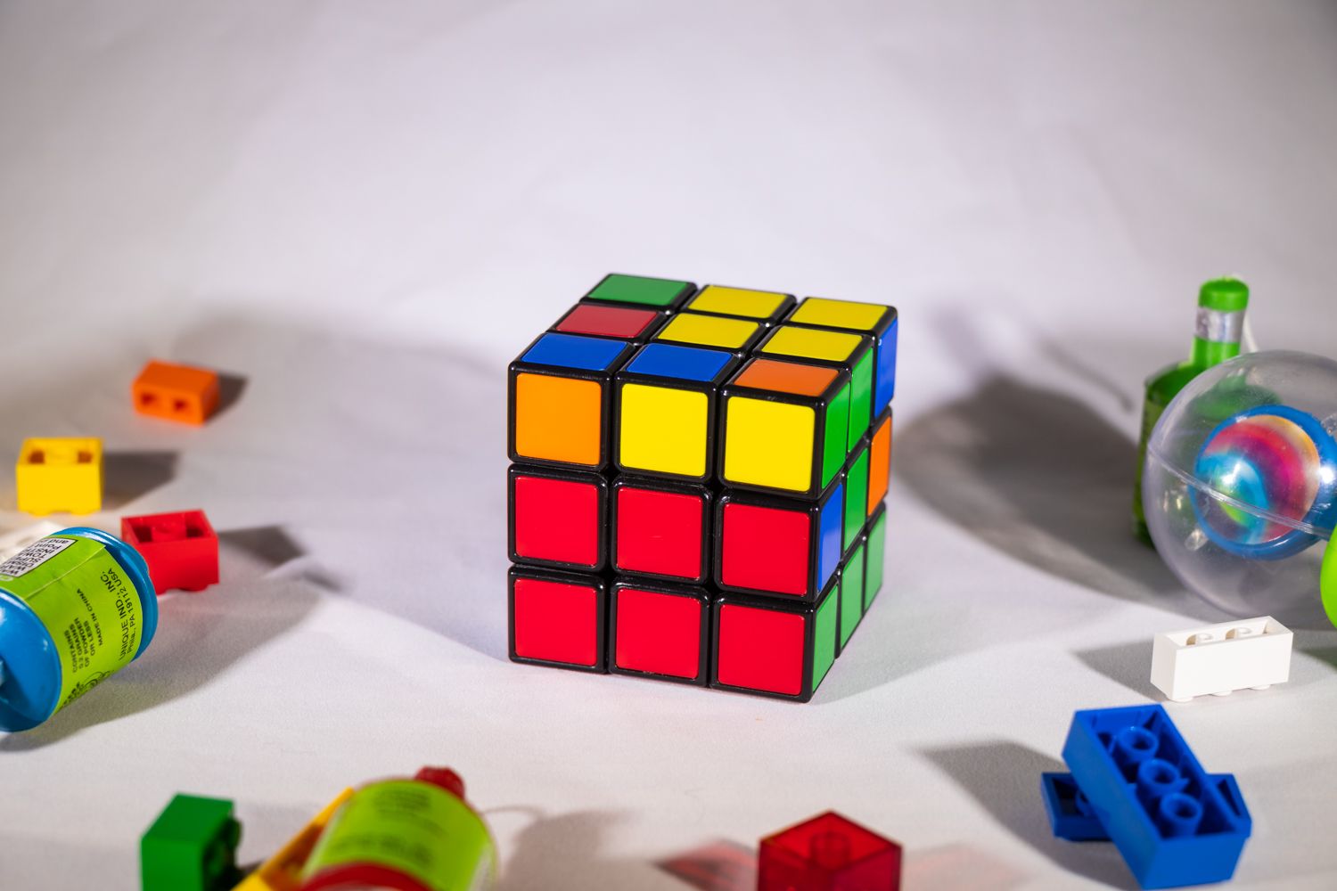 Up close view of Rubik's Cube showing partial completion on a cluttered white table