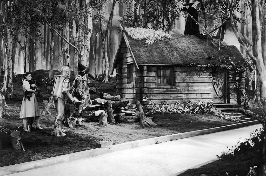 Yellow brick road in front of a cabin in the Wizard of Oz