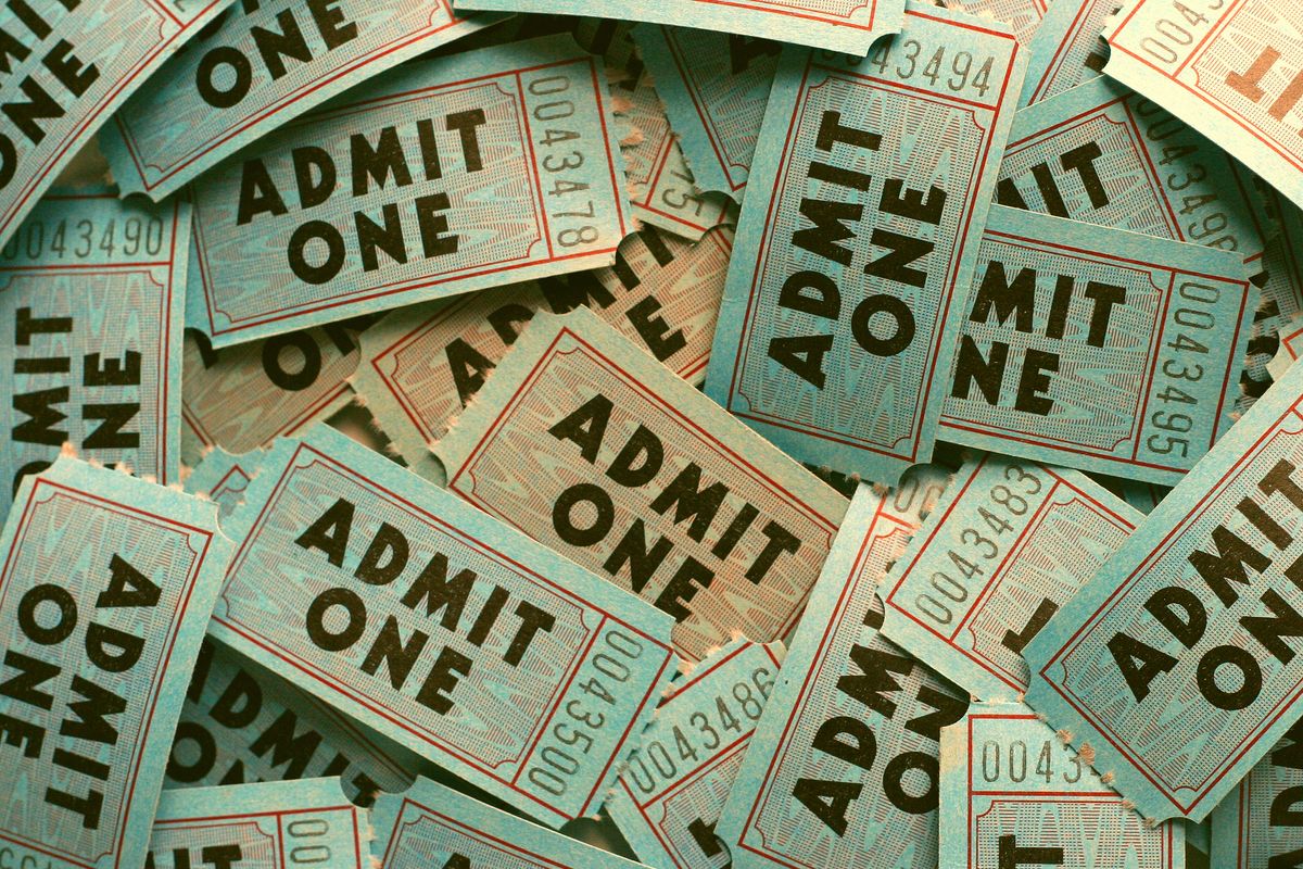 Pile of blue movie tickets labeled "ADMIT ONE"