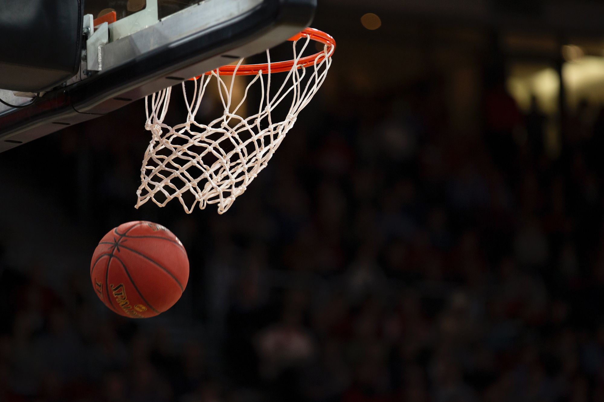 A basketball falling after being shot through a hoop
