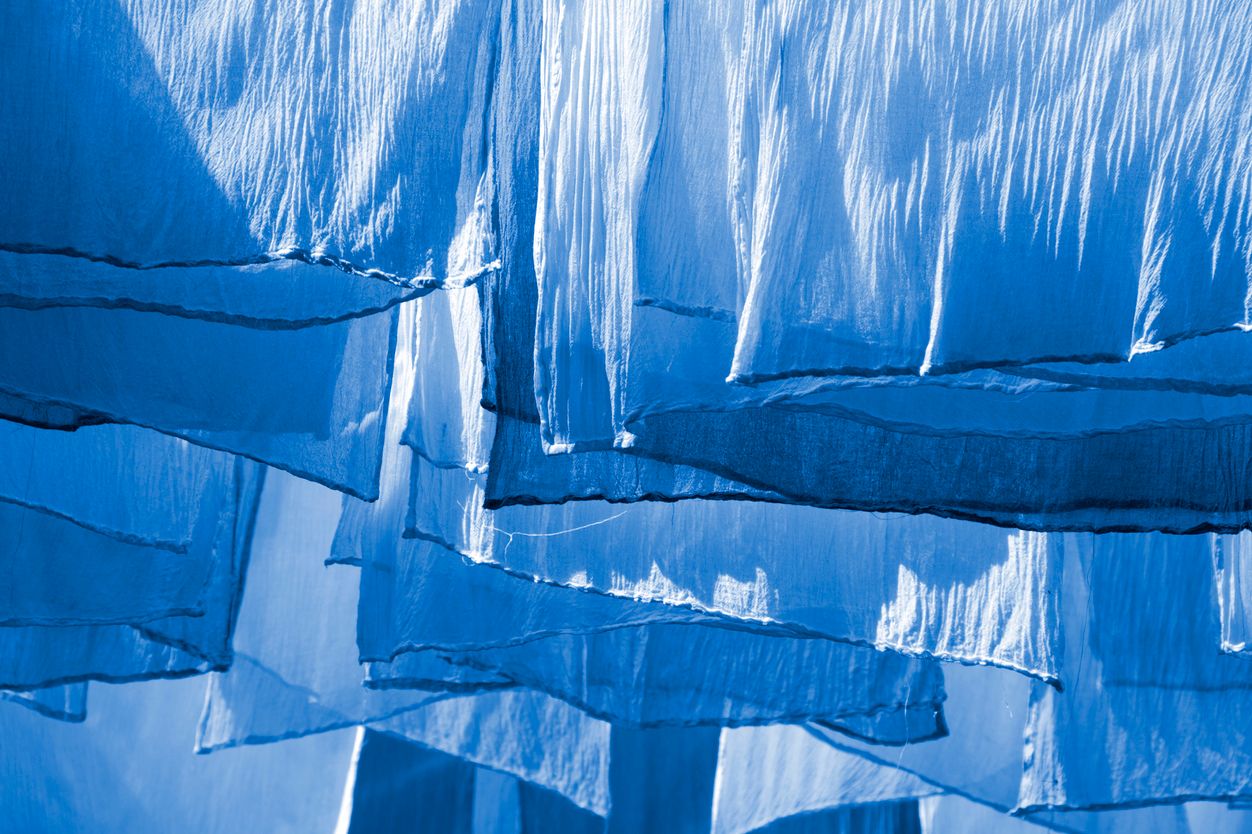 Blue dyed fabrics hanging outside