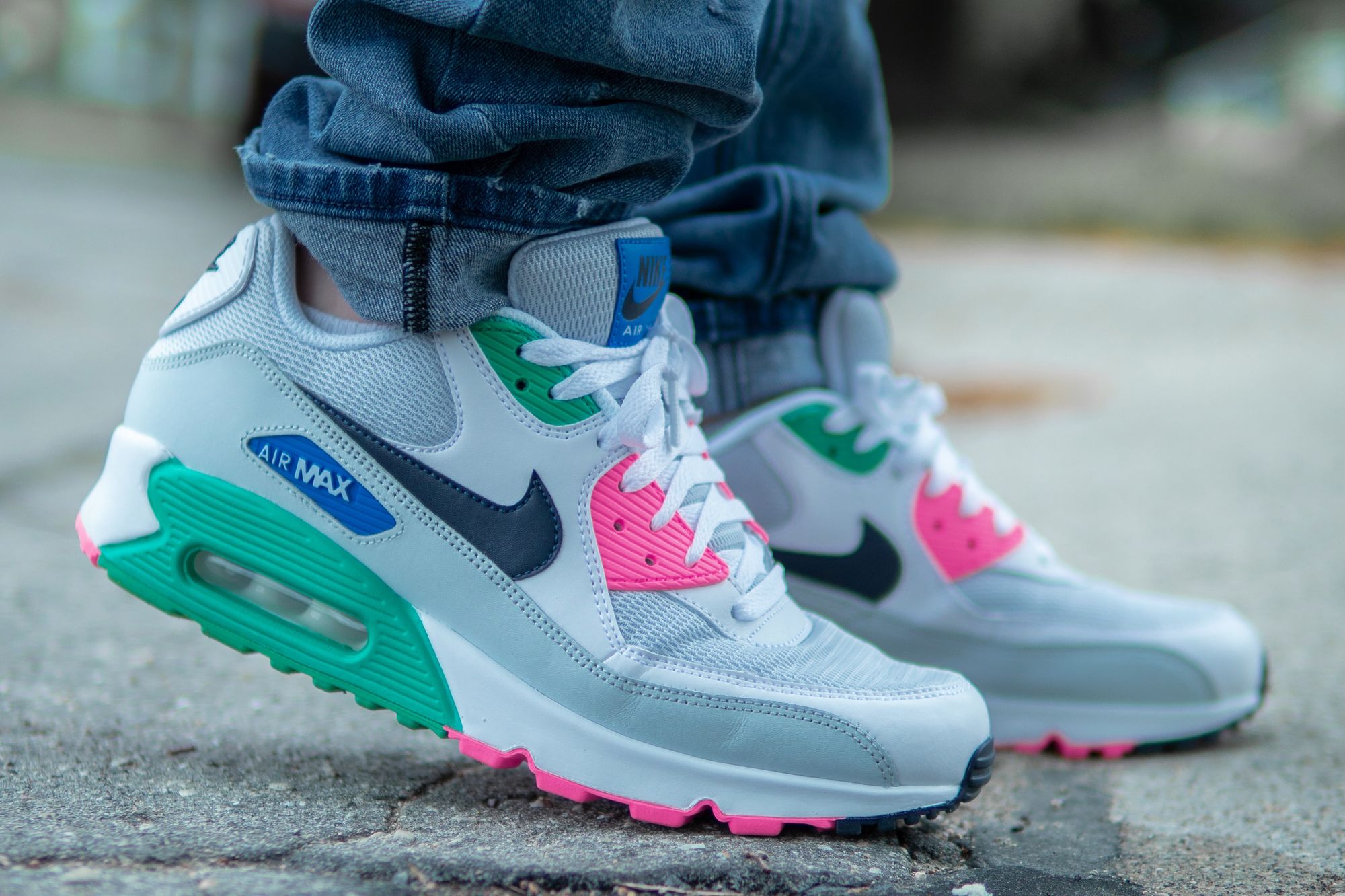 Someone wearing jeans with Nike sneakers