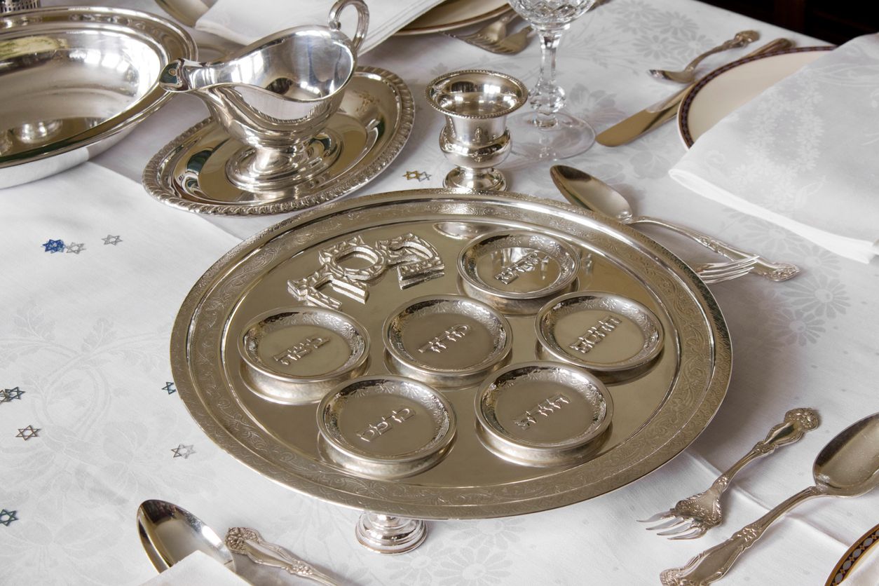 Passover silver plate placed on an elegant table setting