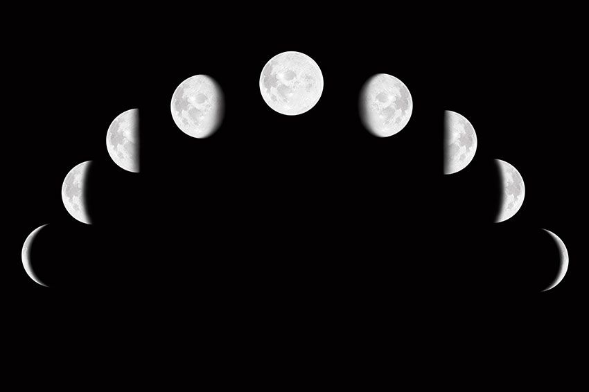 The Moon in different phases against a black sky.