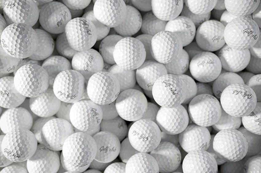 Close up of a pile of golf balls.