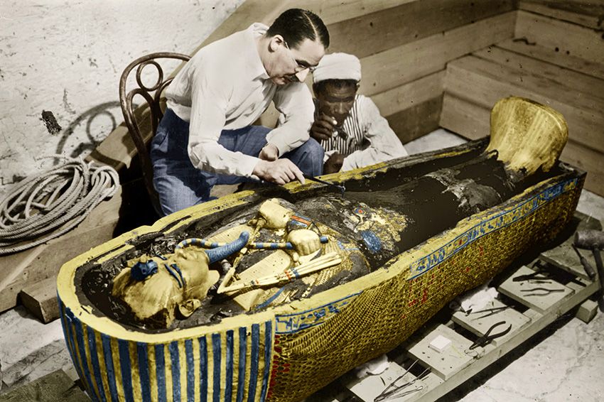 Howard Carter the egyptologist and assistant near golden sarcophagus of Tutankhamen (mummy) in Egypt