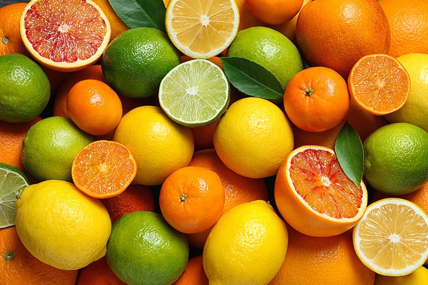 Cut up and whole grapefruits, lemons, oranges, and limes.