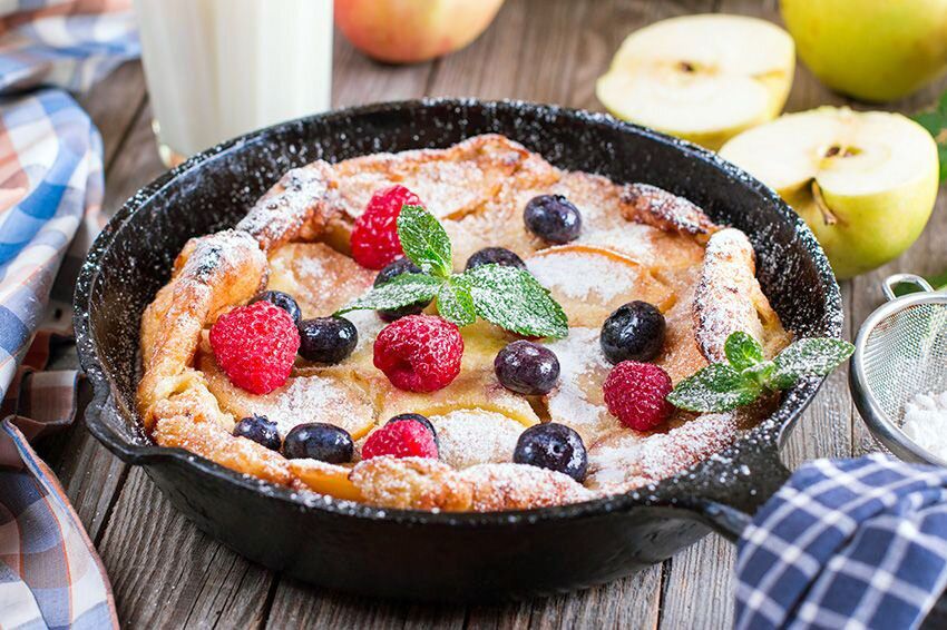 Dutch baby pancake with apple, cinnamon, blueberry, and raspberry.